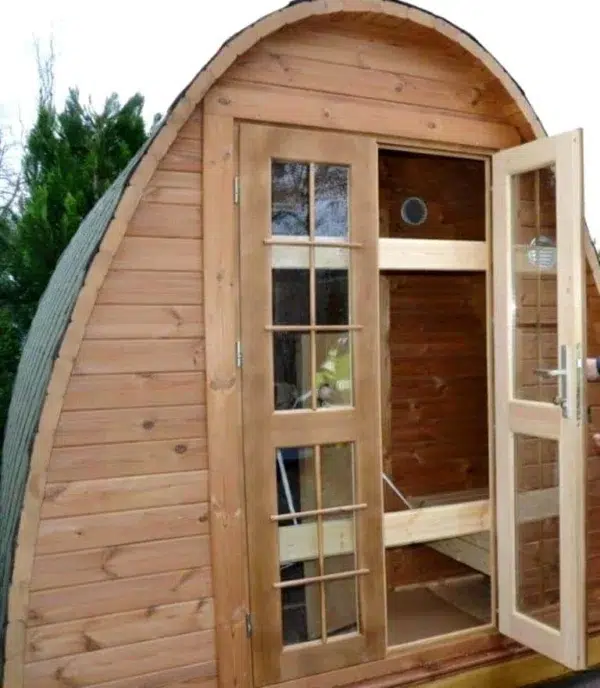 Outdoor pod sauna, open front doors revealing the changing area