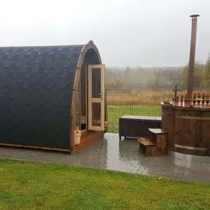 Outdoor pod sauna, side exterior beside an outdoor hot tub