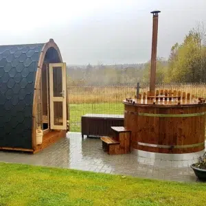 Outdoor pod sauna, side exterior beside a wood-fired hot tub