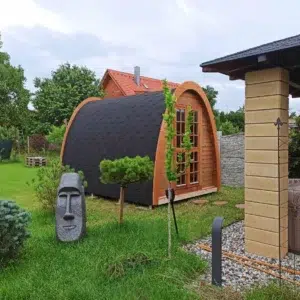 Outdoor pod sauna, side and front exterior in a garden