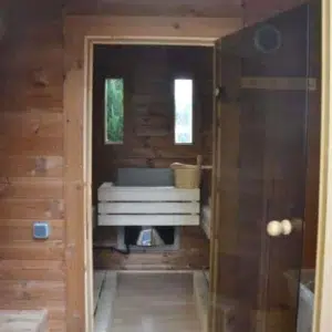 Outdoor pod sauna, view through changing area toward sauna benches