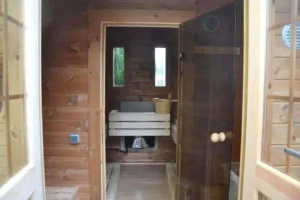 Outdoor pod sauna, view through changing area toward sauna benches