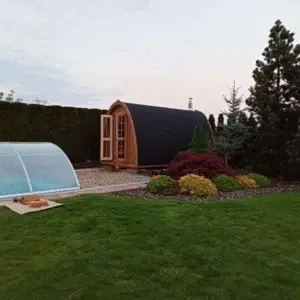 Outdoor pod sauna, wide garden installation beside a pool