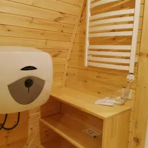 Wooden camping pod, bathroom water heater, washbasin and towel rail