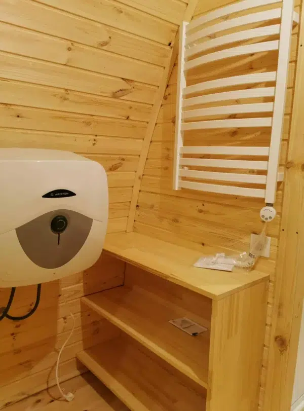 Wooden camping pod, bathroom water heater, washbasin and towel rail