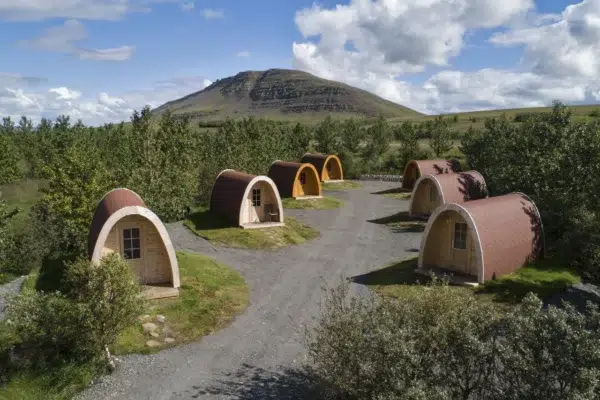 Wooden camping pod, camping pods arranged along gravel paths