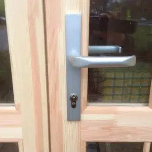 Wooden camping pod, close-up of entrance handle and lock