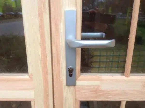 Wooden camping pod, close-up of entrance handle and lock