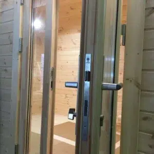 Wooden camping pod, close-up of entrance handles and locking hardware