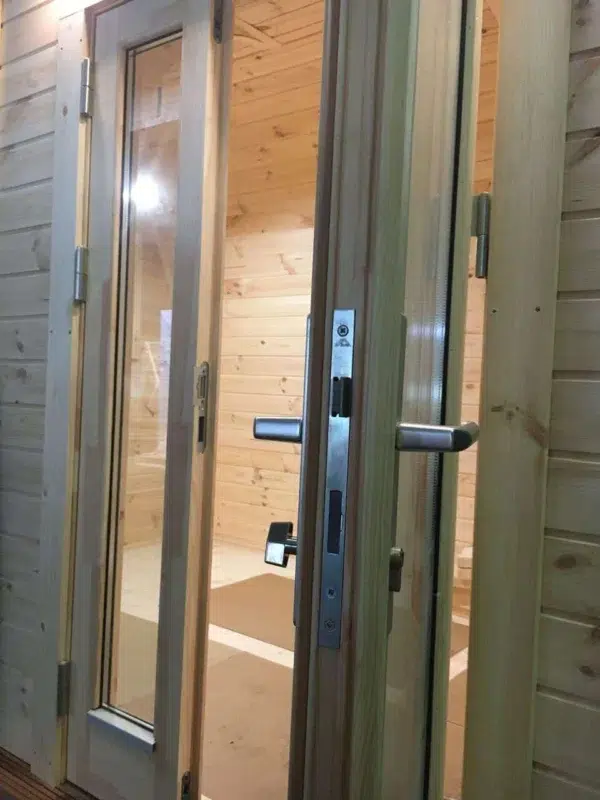 Wooden camping pod, close-up of entrance handles and locking hardware