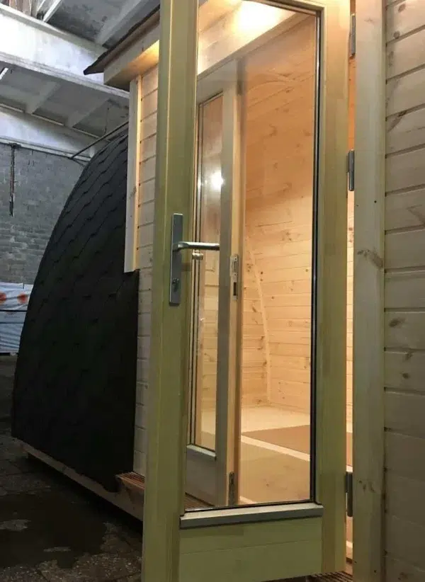 Wooden camping pod, close-up of glazed double entrance doors