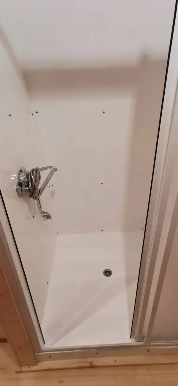 Wooden camping pod, close-up of shower controls