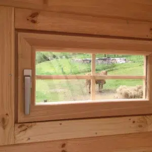 Wooden camping pod, close-up of wooden-framed window