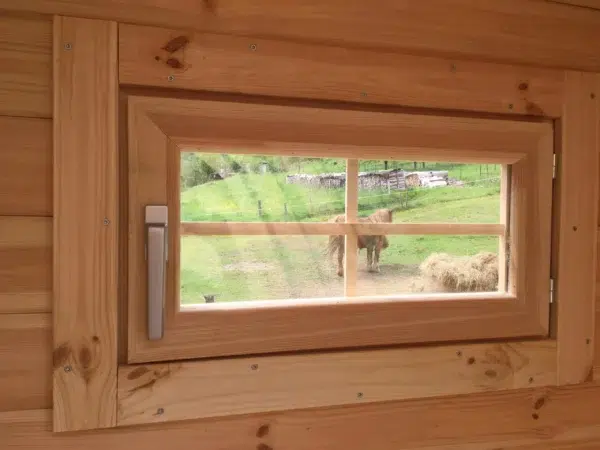 Wooden camping pod, close-up of wooden-framed window