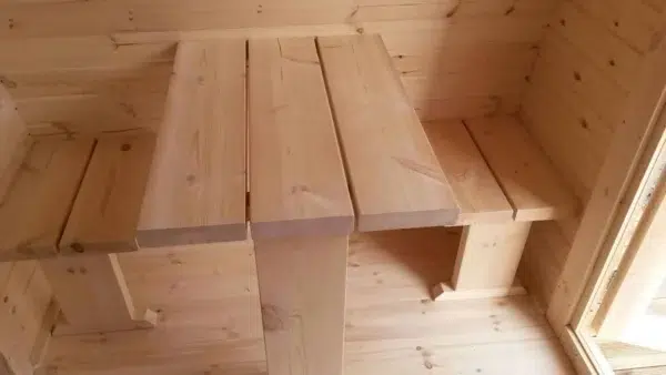 Wooden camping pod, close-up of wooden table construction