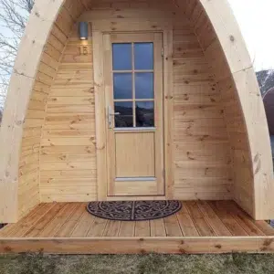 Wooden camping pod, covered front porch and glazed door