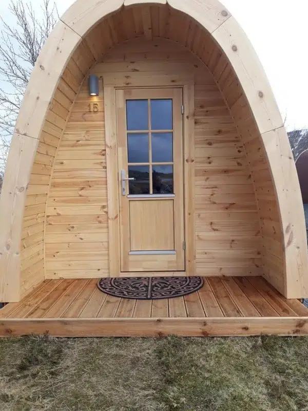 Wooden camping pod, covered front porch and glazed door