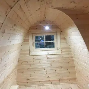 Wooden camping pod, curved interior wall and small window