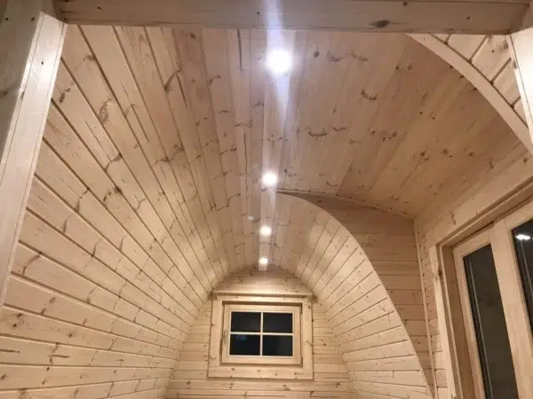 Wooden camping pod, curved wooden ceiling with recessed lights