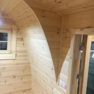 Wooden camping pod, curved wooden interior partition and doorway