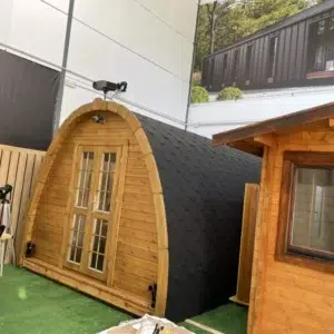 Wooden camping pod, display installation with glazed double doors