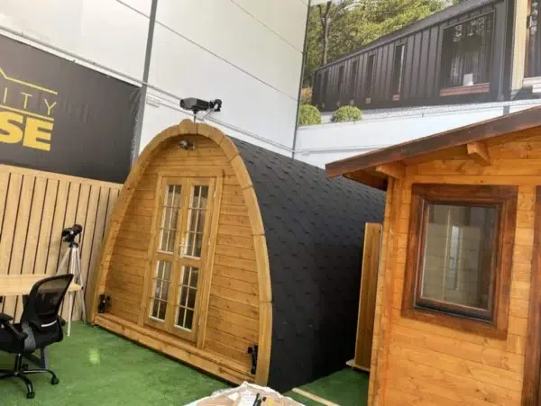 Wooden camping pod, display installation with glazed double doors