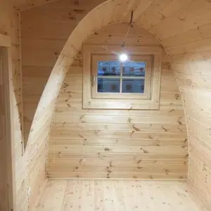 Wooden camping pod, empty wooden room with curved ceiling