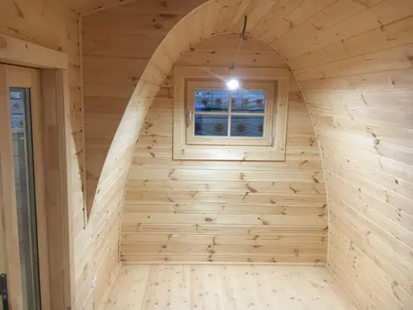 Wooden camping pod, empty wooden room with curved ceiling