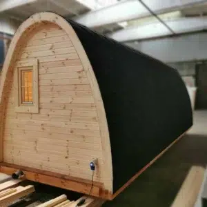 Wooden camping pod, end wall and side roof in a workshop