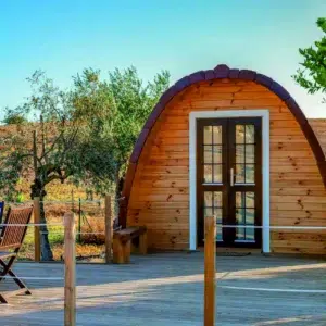 Wooden camping pod, front entrance with broad wooden deck