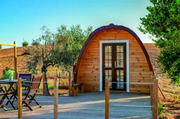 Wooden camping pod, front entrance with broad wooden deck