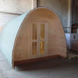 Wooden camping pod, front exterior with arched roof and double doors