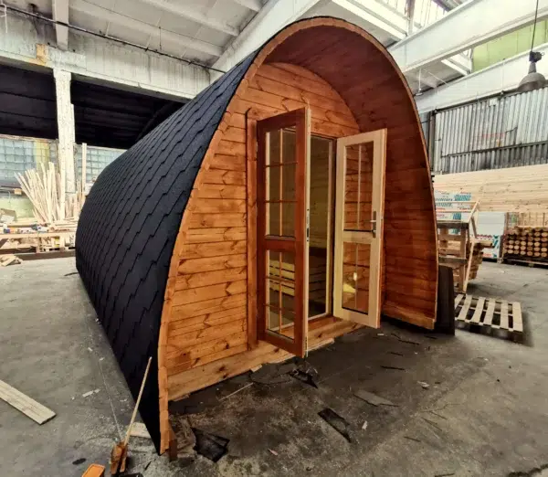 Wooden camping pod, front exterior with open glazed doors