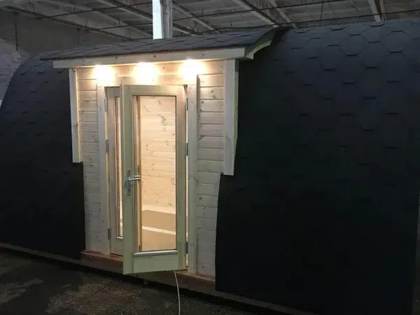 Wooden camping pod, illuminated side entrance and double doors