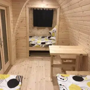 Wooden camping pod, interior beds and small wooden table