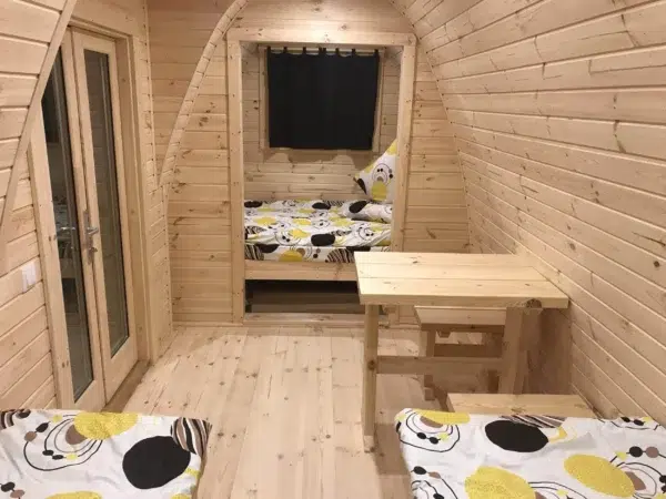 Wooden camping pod, interior beds and small wooden table