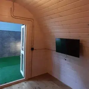 Wooden camping pod, interior entrance and wall-mounted television