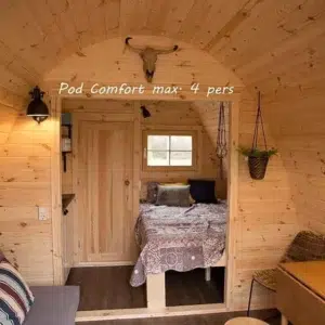 Wooden camping pod, interior sofa, dining area and separate bed