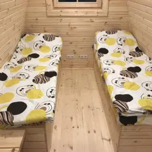 Wooden camping pod, interior twin beds with central aisle