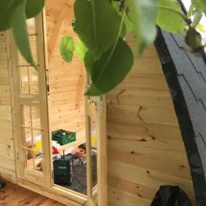 Wooden camping pod, interior view of curved roof glazing
