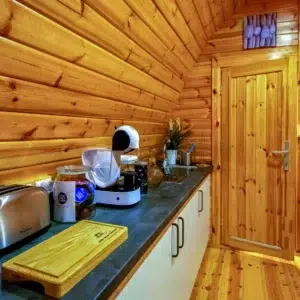 Wooden camping pod, kitchen counter with appliances