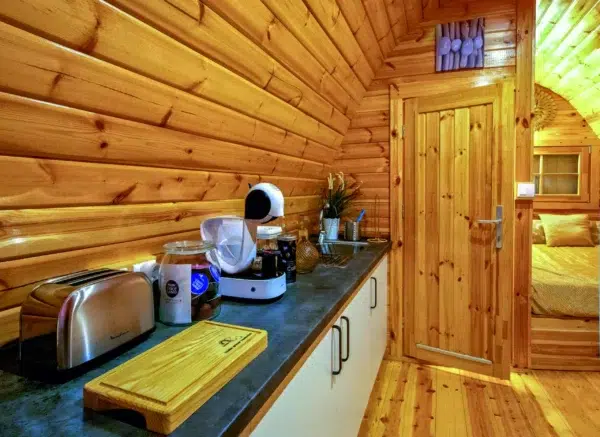Wooden camping pod, kitchen counter with appliances