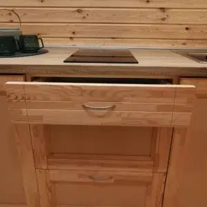 Wooden camping pod, kitchen drawer beneath countertop