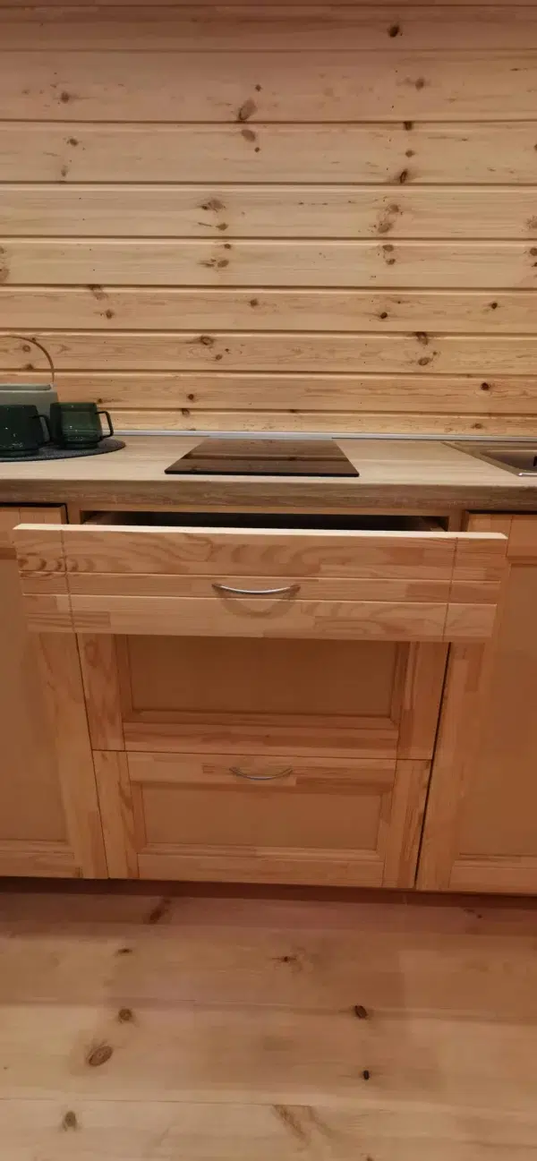 Wooden camping pod, kitchen drawer beneath countertop