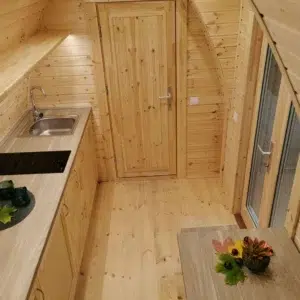 Wooden camping pod, kitchenette and glass entrance doors
