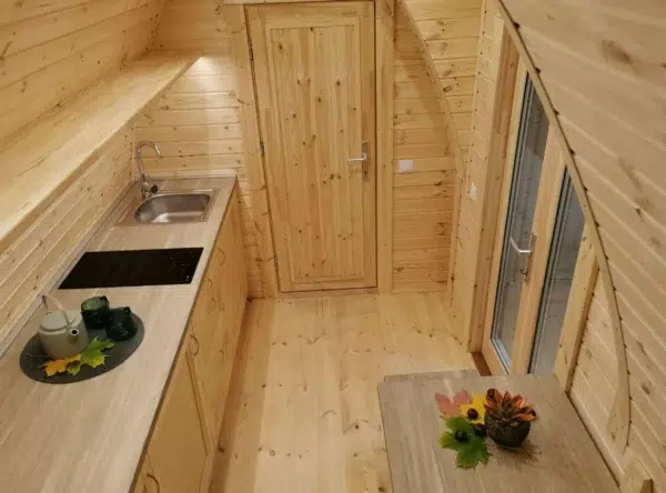 Wooden camping pod, kitchenette and glass entrance doors