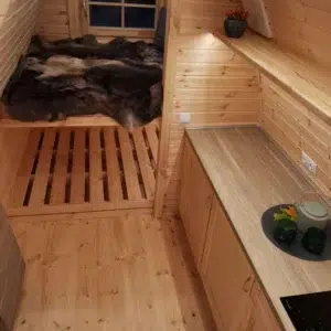 Wooden camping pod, kitchenette and raised sleeping platforms