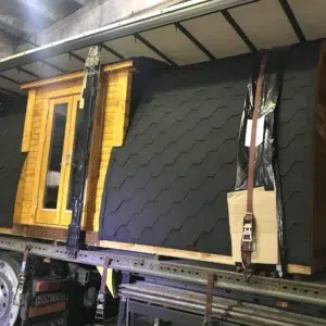 Wooden camping pod, loaded on a transport truck