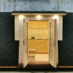 Wooden camping pod, open double doors revealing kitchenette