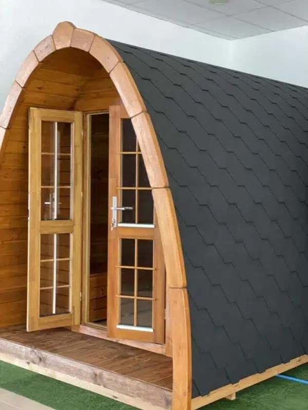 Wooden camping pod, open front doors and curved roof